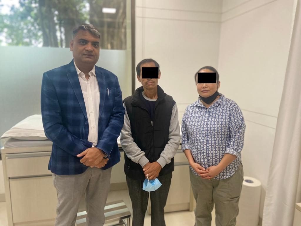 Dr Manoj Gupta with a patient and family at follow-up