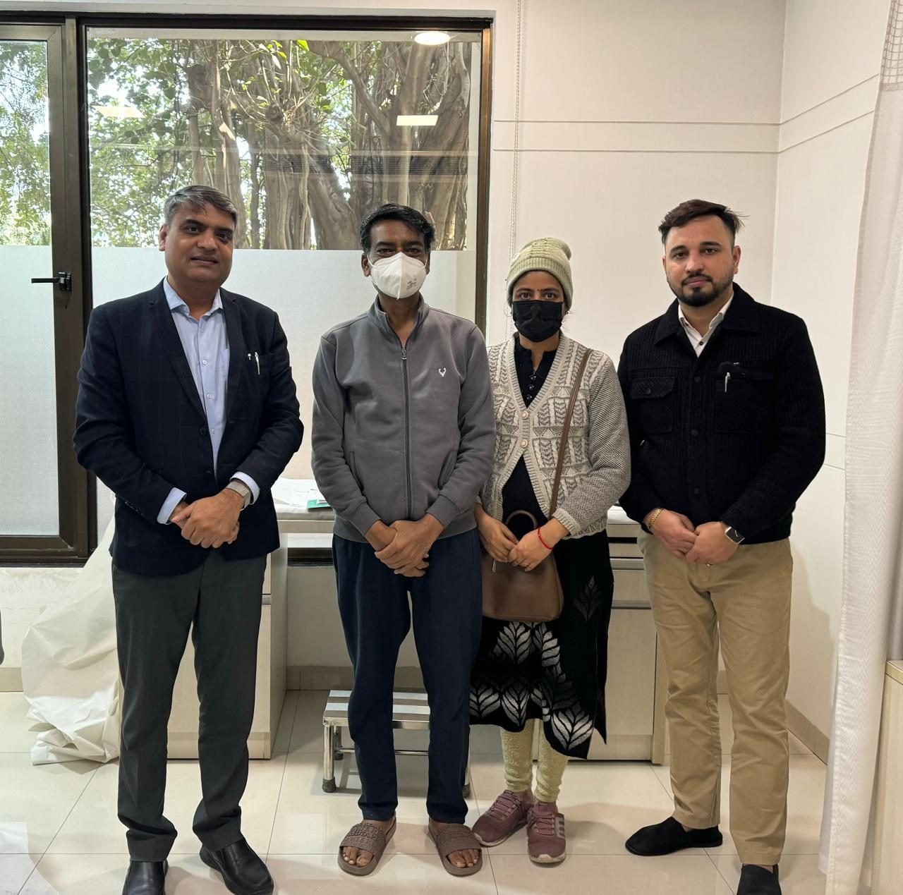 Patient and family with Dr Manoj Gupta at a winter follow-up